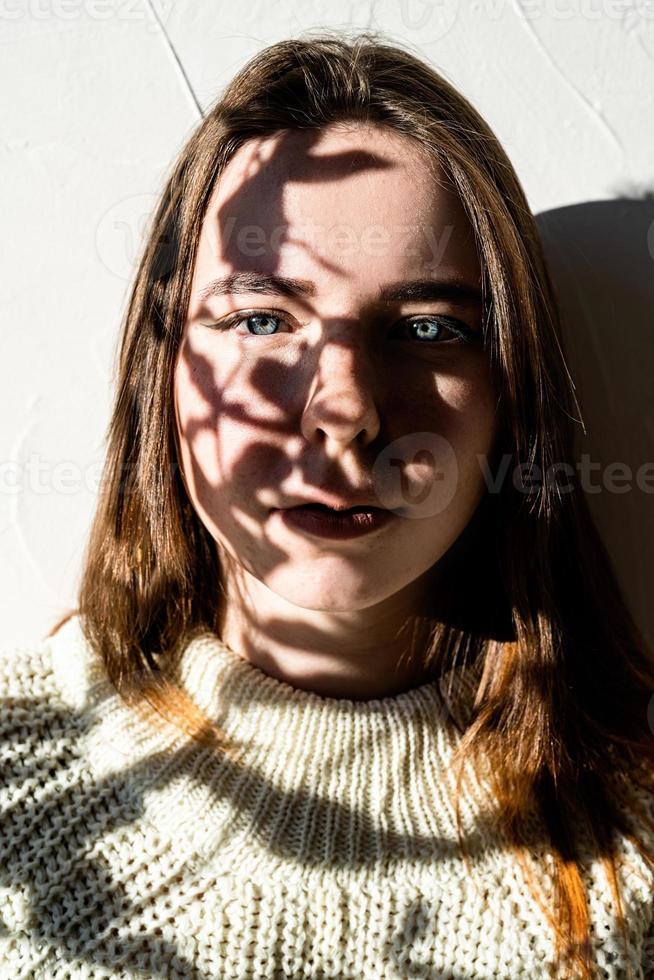 Portrait of a beautiful young woman with a shadow pattern on the face and body photo