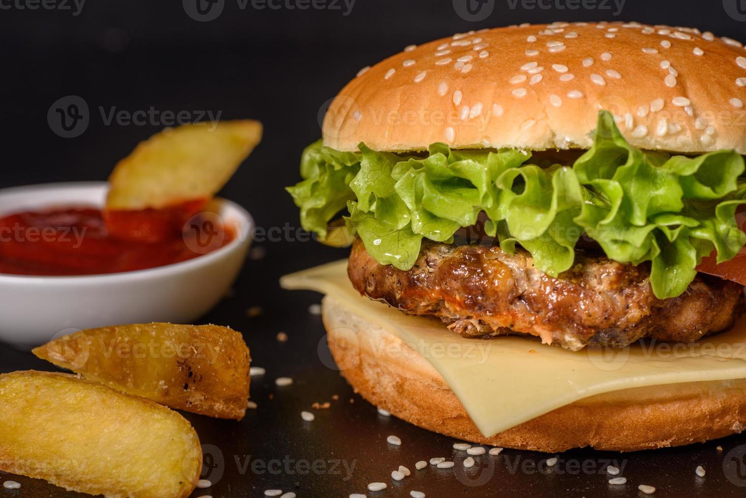 Tasty grilled homemade burger with beef, tomato, cheese, cucumber and lettuce photo