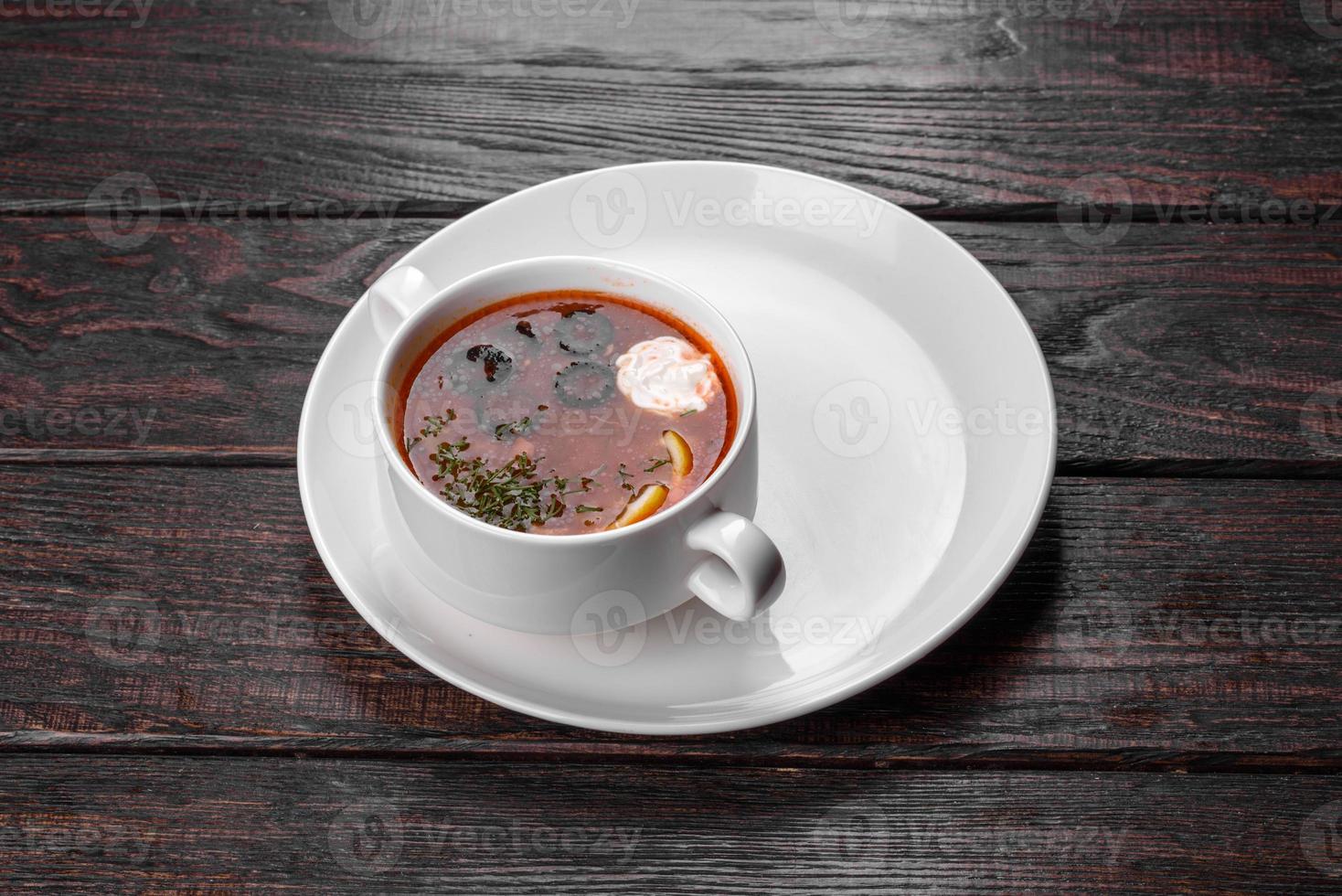 Appetizing dish of russian hodgepodge soup in ceramic pot photo