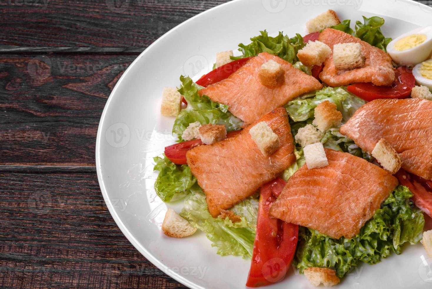 Delicious fresh salad with red fish for the festive table photo