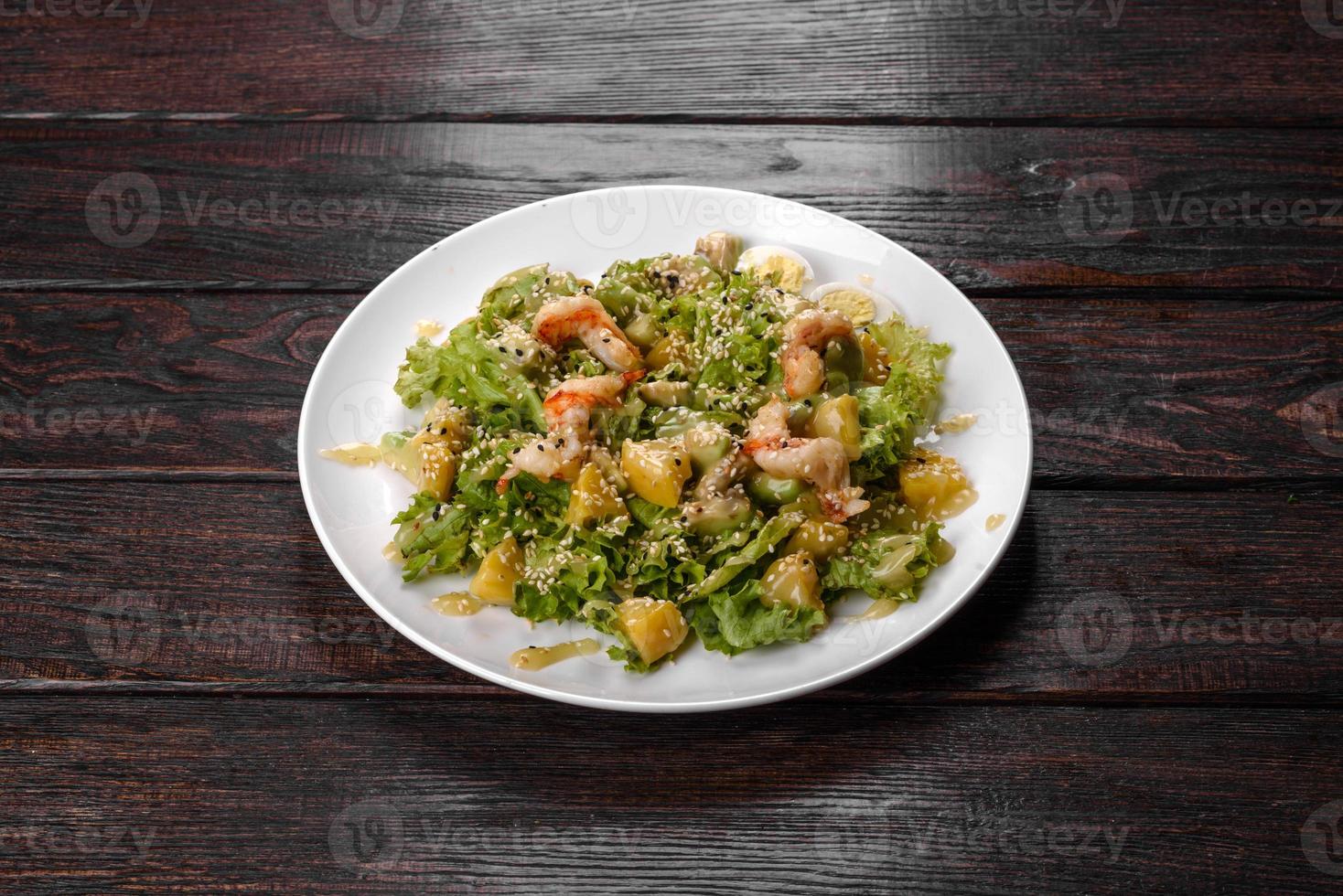 Delicious fresh salad with shrimp and pear for the festive table photo