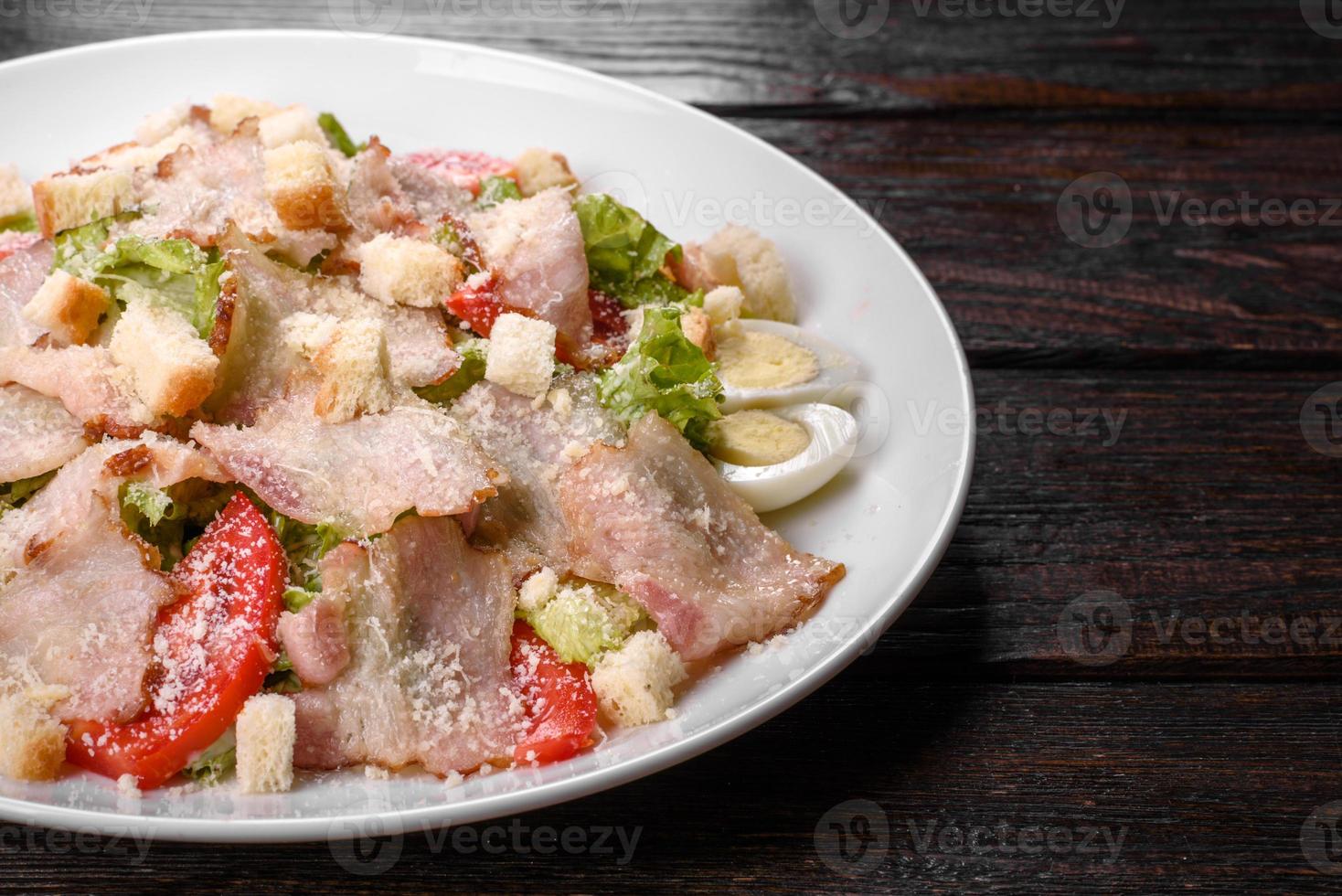 Delicious fresh salad with bacon and tomatoes with spices and greens photo