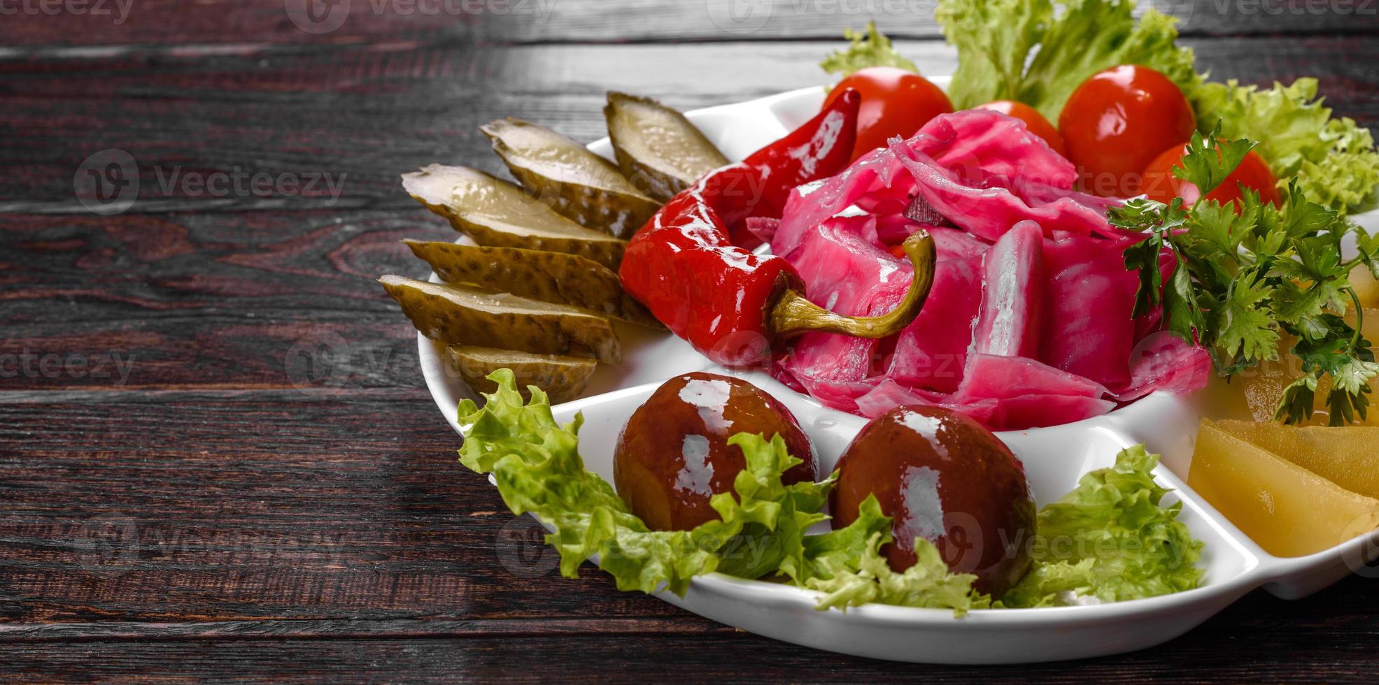 Delicious spicy pickles cut on a serving plate photo