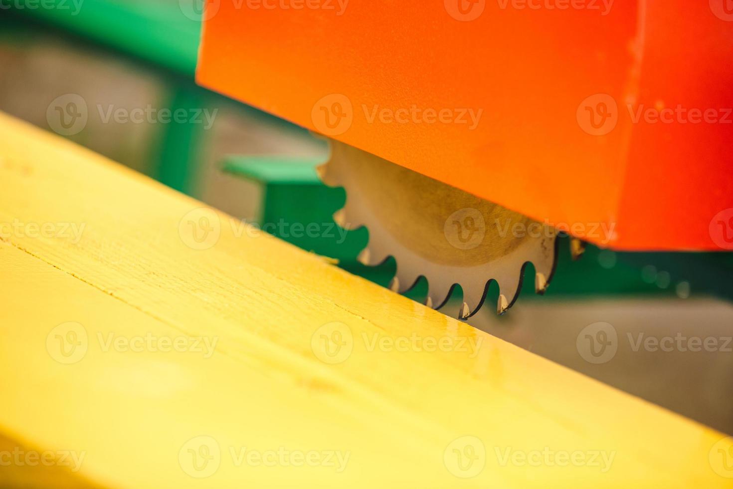 wood cutting machine. Close up electric circular saw cutting wood and iron ruler. photo