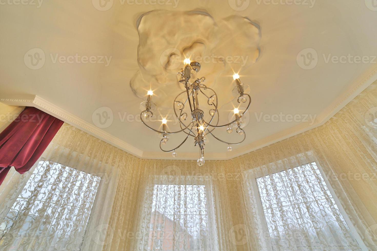Close up on crystal of contemporary chandelier, is a branched ornamental light fixture designed to be mounted on ceilings or walls. vintage chandelier. photo