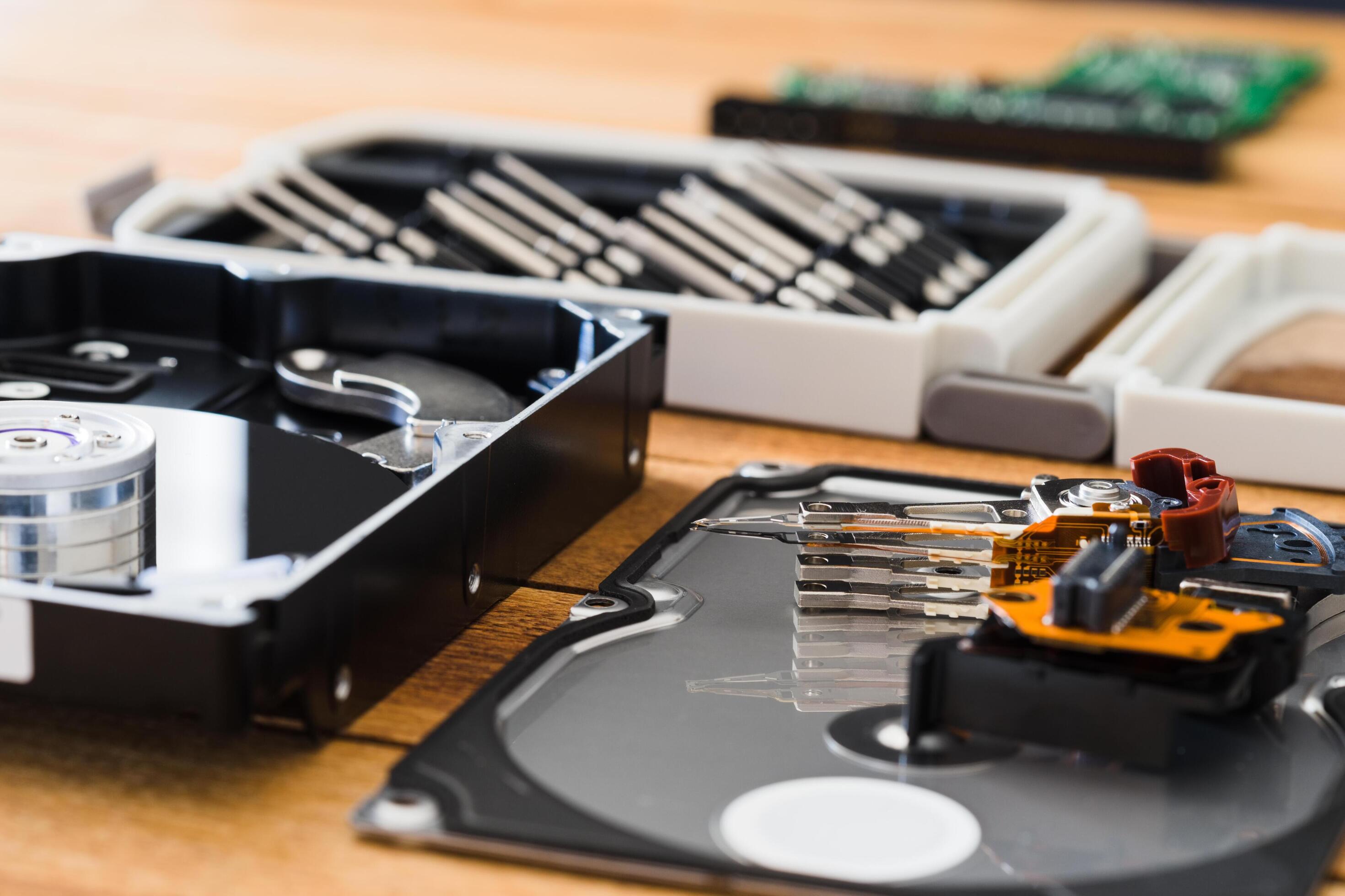 Disassembled hard disk drive inside closeup, spindle, actuator arm