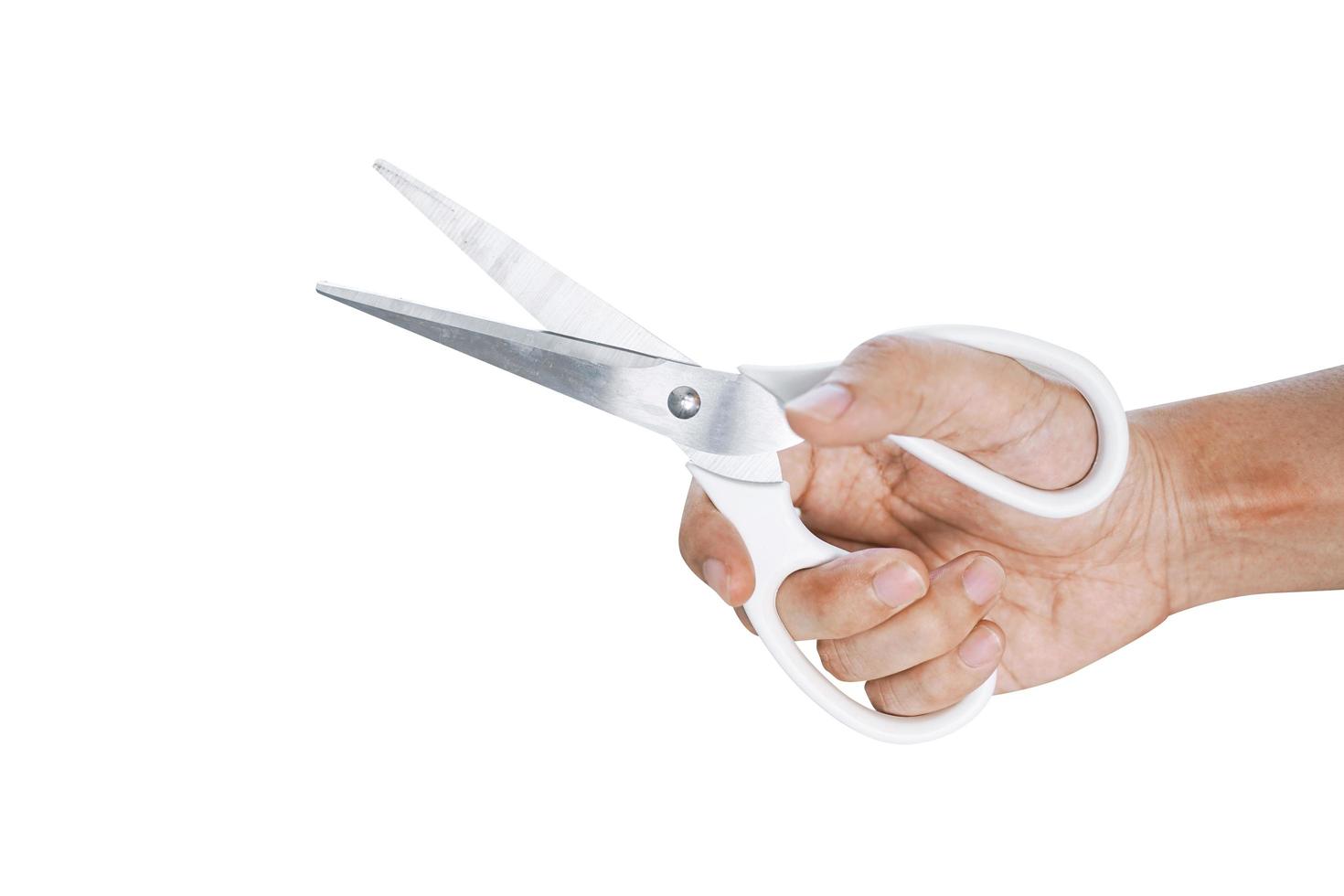 Hand is holding white scissors isolated on white background photo