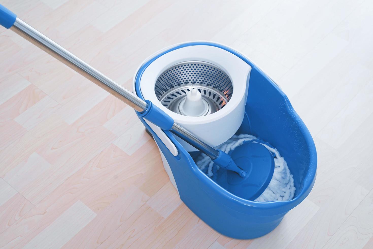 Floor cleaning with mob and bucket. Cleaning floor in the room photo