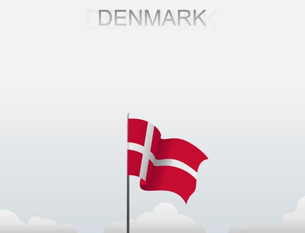 The Danish flag is flying on a pole that stands tall under the white sky vector