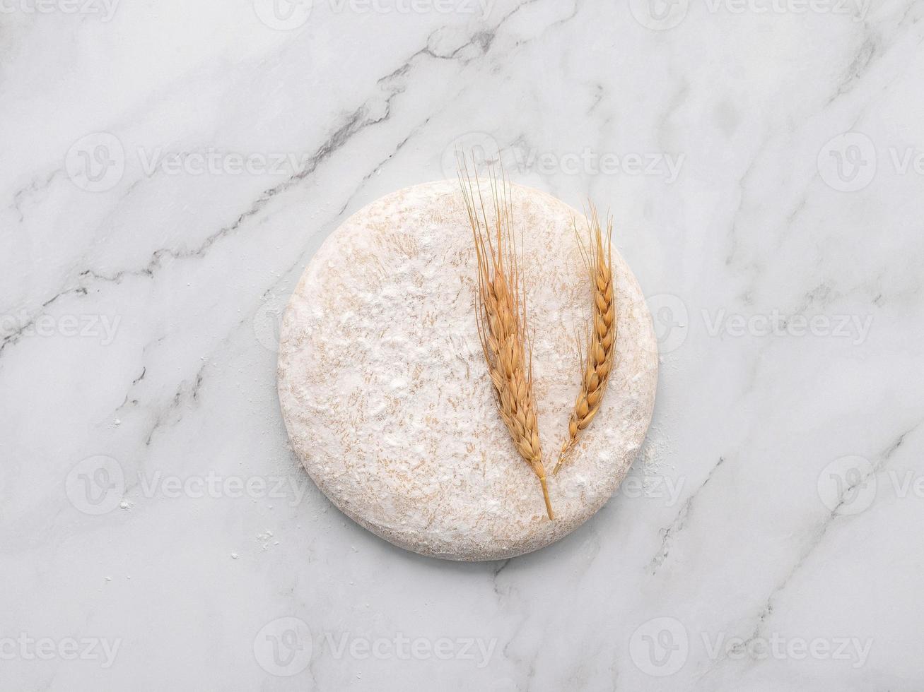 Fresh homemade yeast dough resting on marble table flat lay. photo