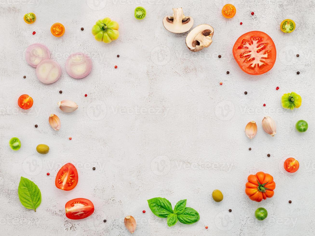 The ingredients for homemade pizza set up on white concrete background. photo