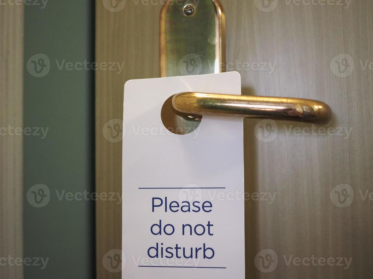 Please do not disturb sign on hotel room door photo