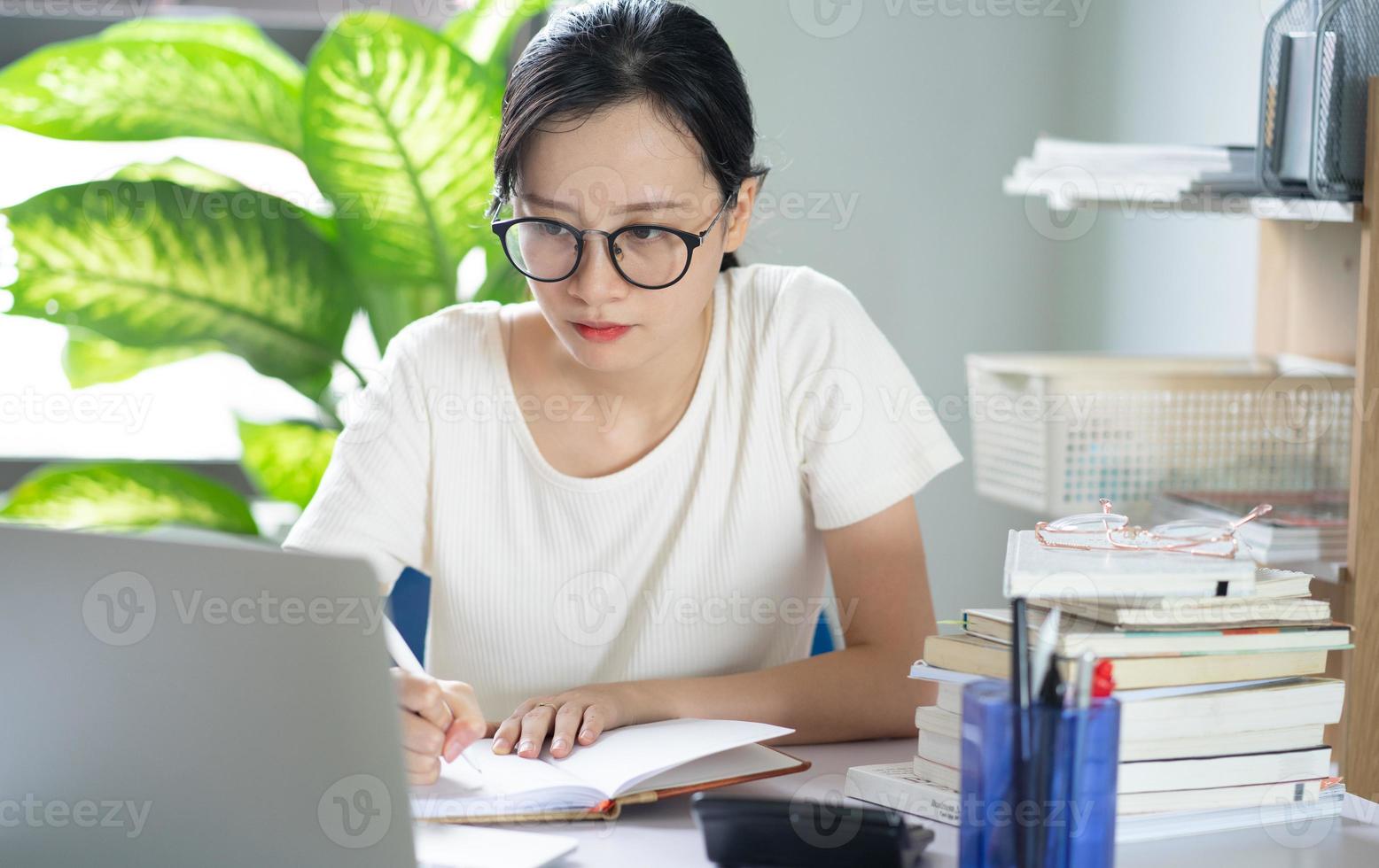Asian young girl doing homework photo