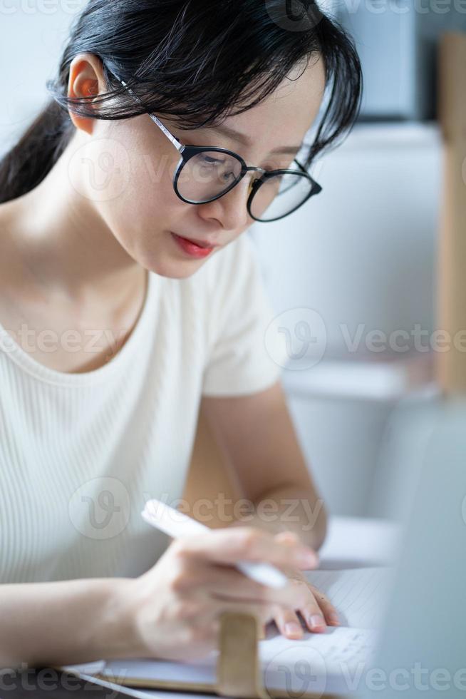 Asian young girl doing homework photo