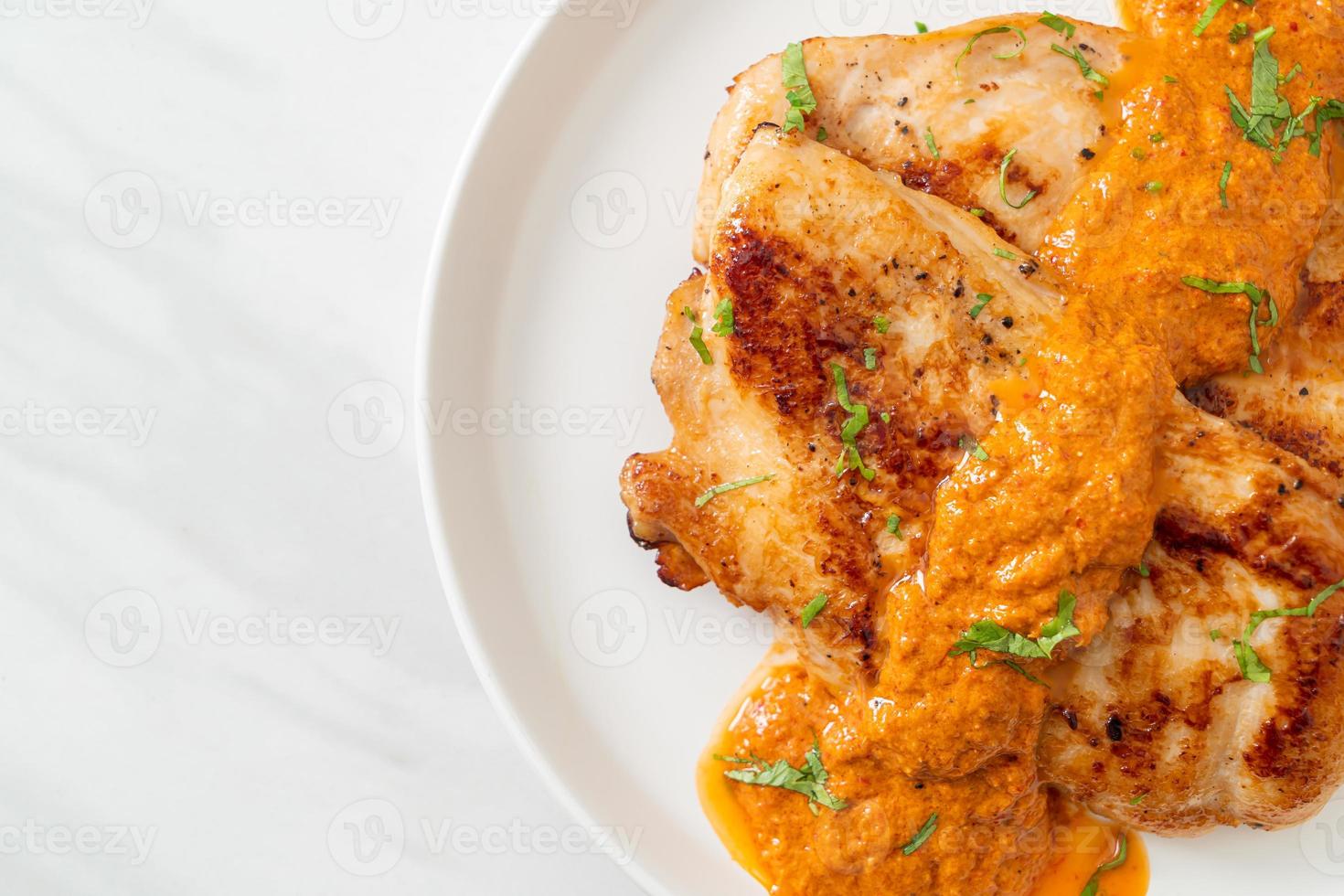 grilled chicken steak with red curry sauce photo