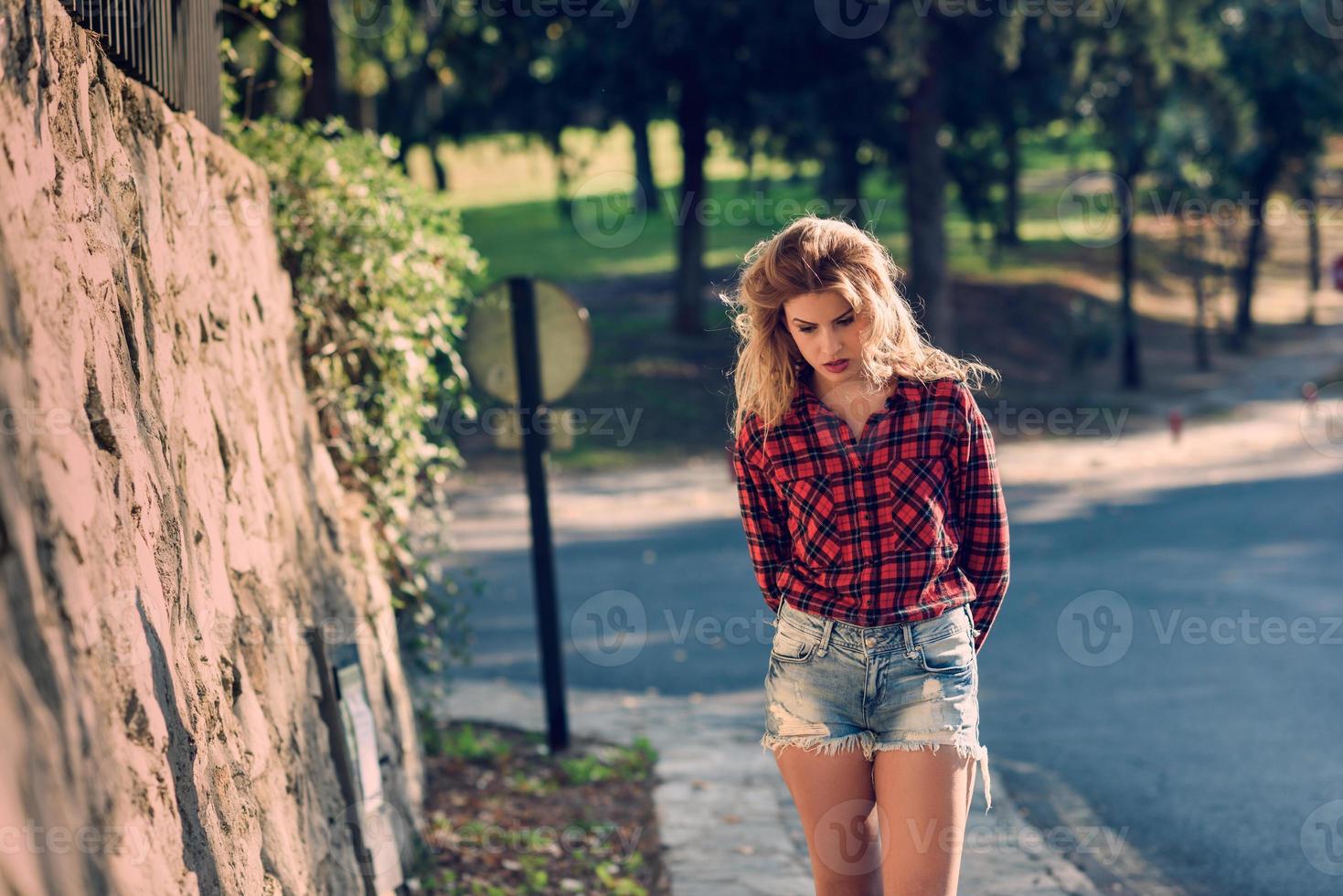 Beautiful woman with long blond curly hair photo