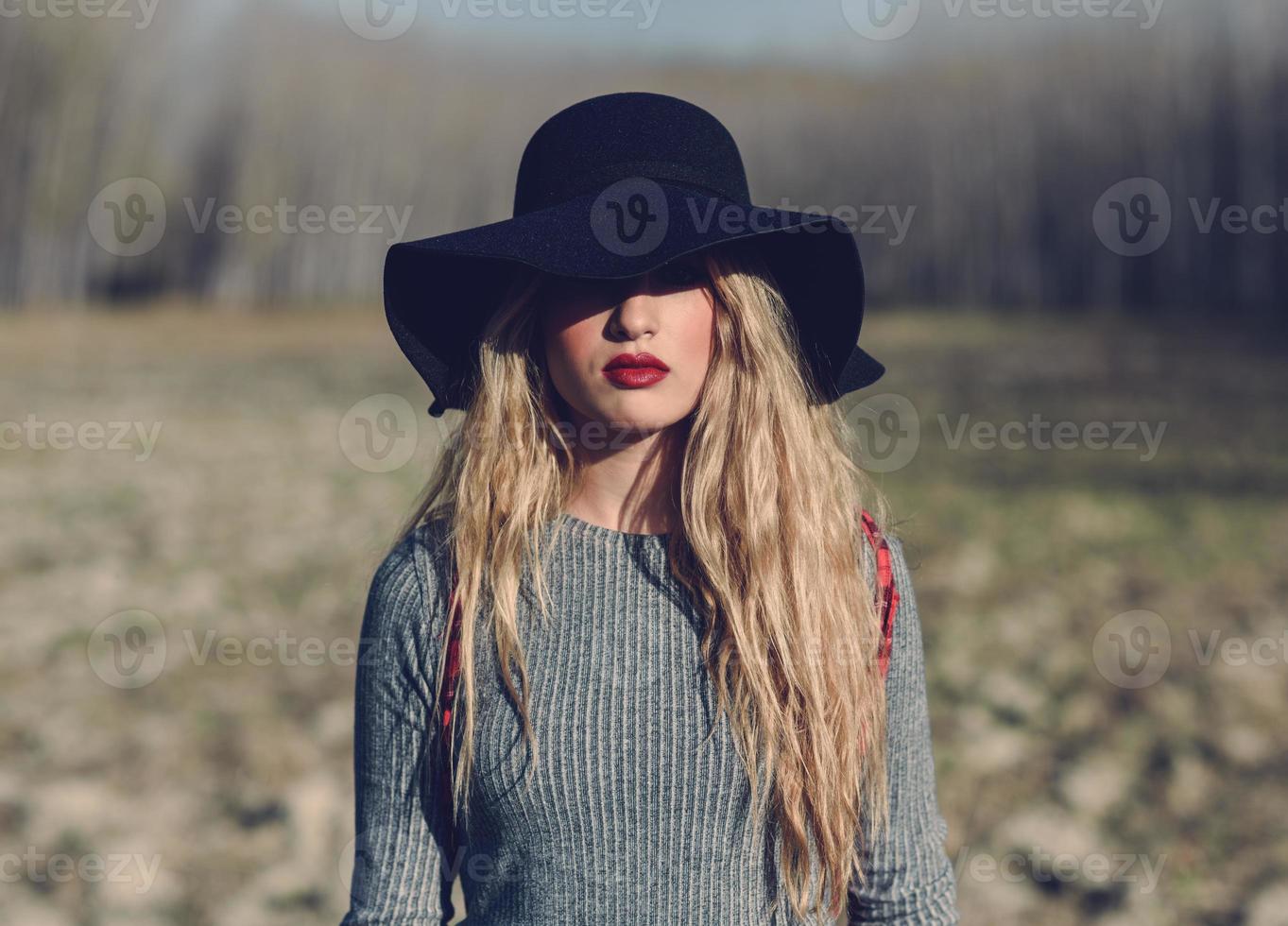 Beautiful young blonde woman in rural background photo