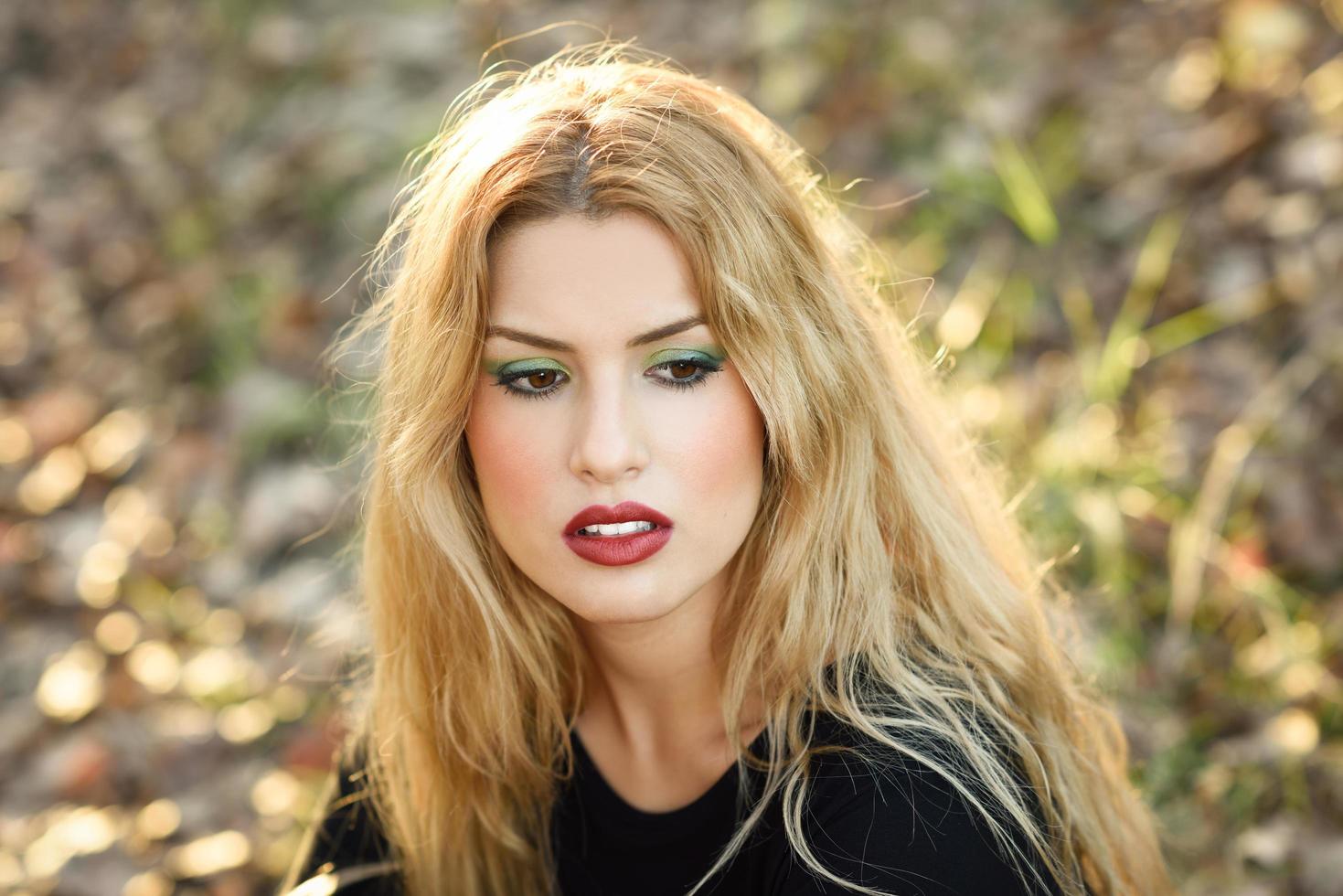 Relaxed girl lying on the field with long curly hair. photo