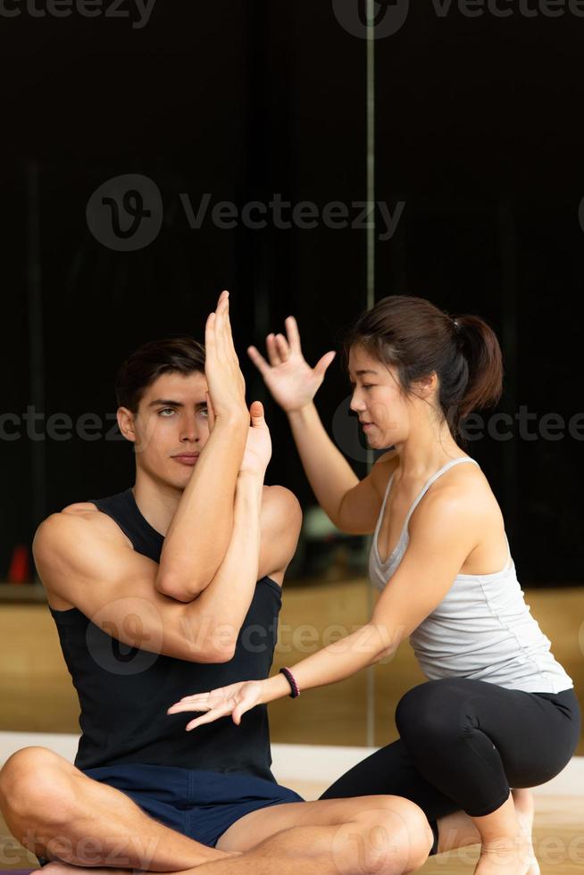 Yoga class of young people interested in yoga activities With a yoga teacher photo