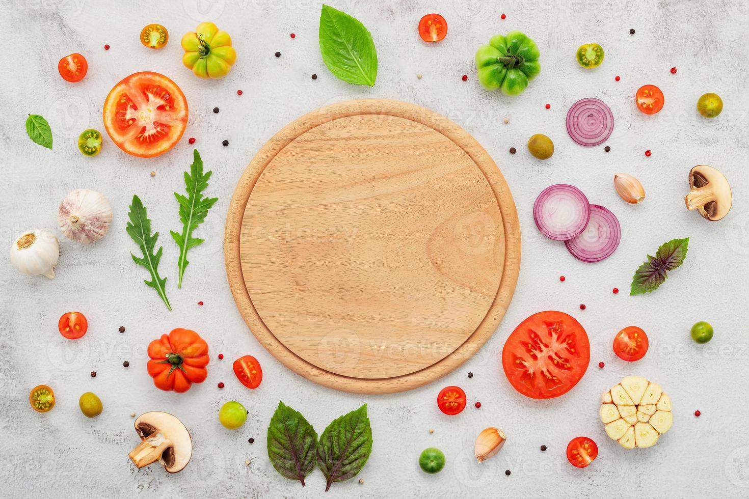 The ingredients for homemade pizza set up on white concrete background  flat lay and copy space. photo