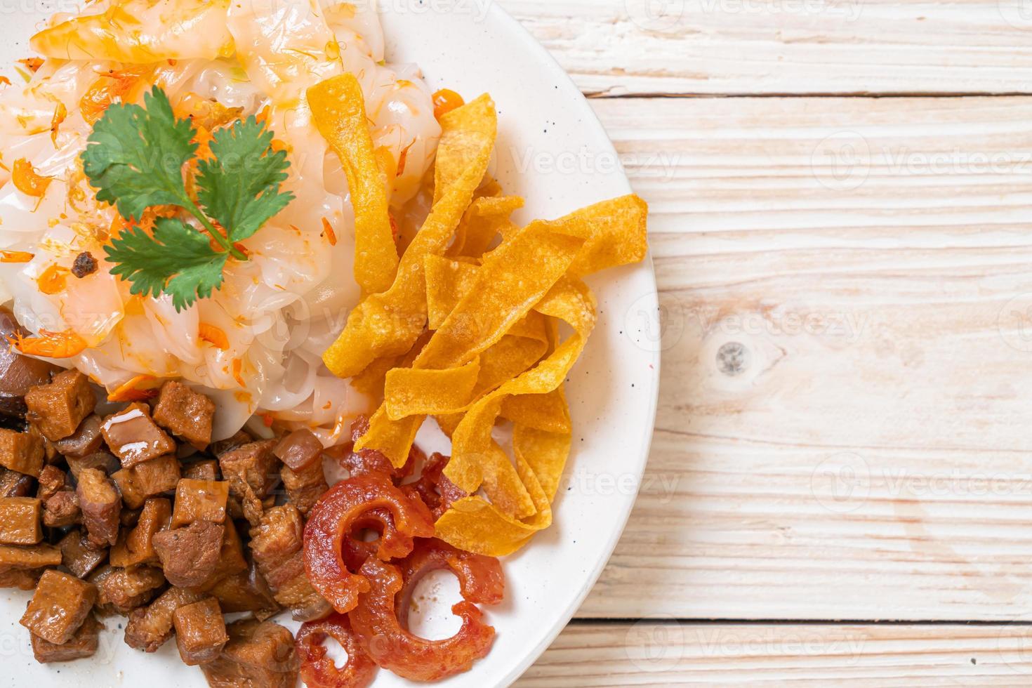 Fideos chinos de arroz al vapor con cerdo y tofu en salsa de soja dulce foto