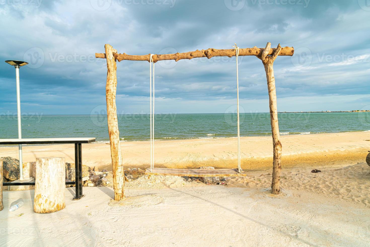 wooden swing on the beach photo