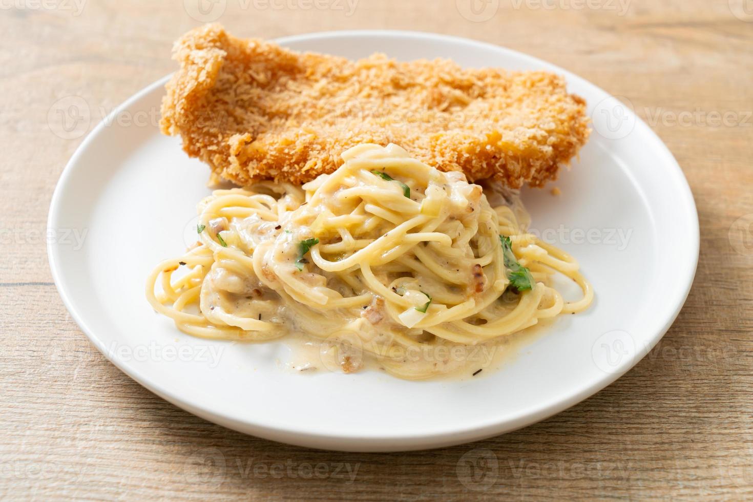 spaghetti pasta white cream sauce with fried fish photo