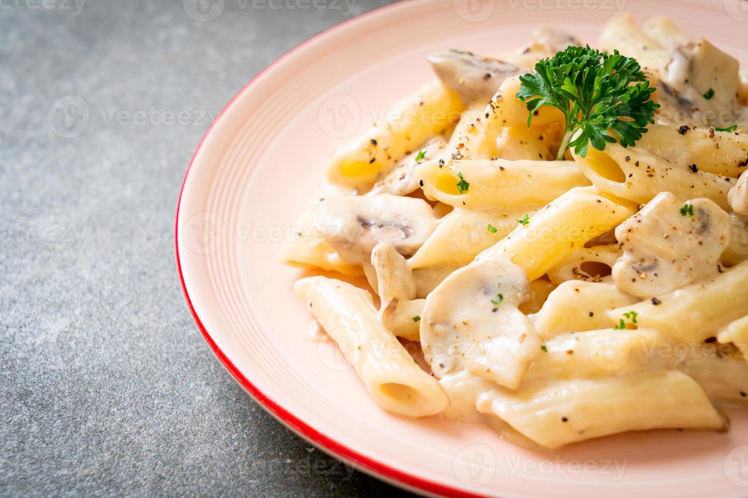 penne pasta carbonara cream sauce with mushroom photo