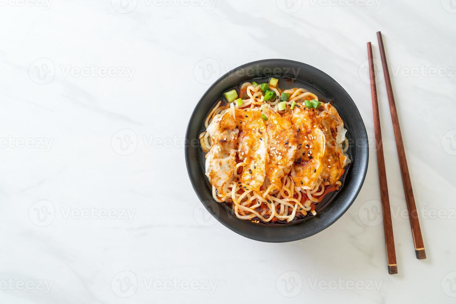 ramen noodles with gyoza or pork dumplings photo