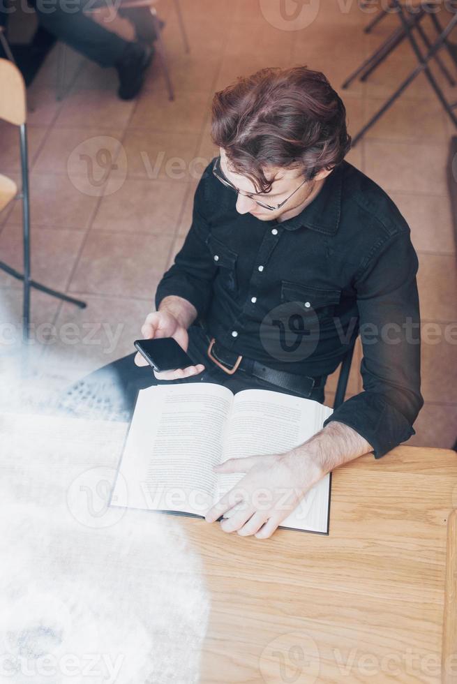Young entrepreneur working in a cafe photo
