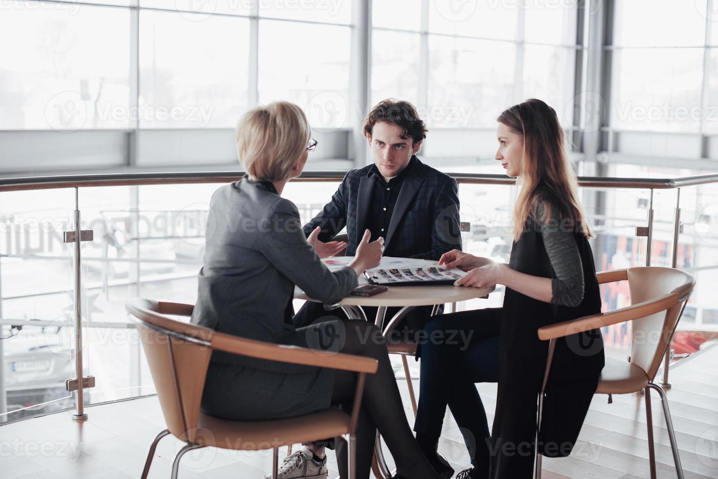 Team job succes. Photo young business managers working with new startup project in office. Analyze document, plans. Generic design notebook on wood table, papers, documents