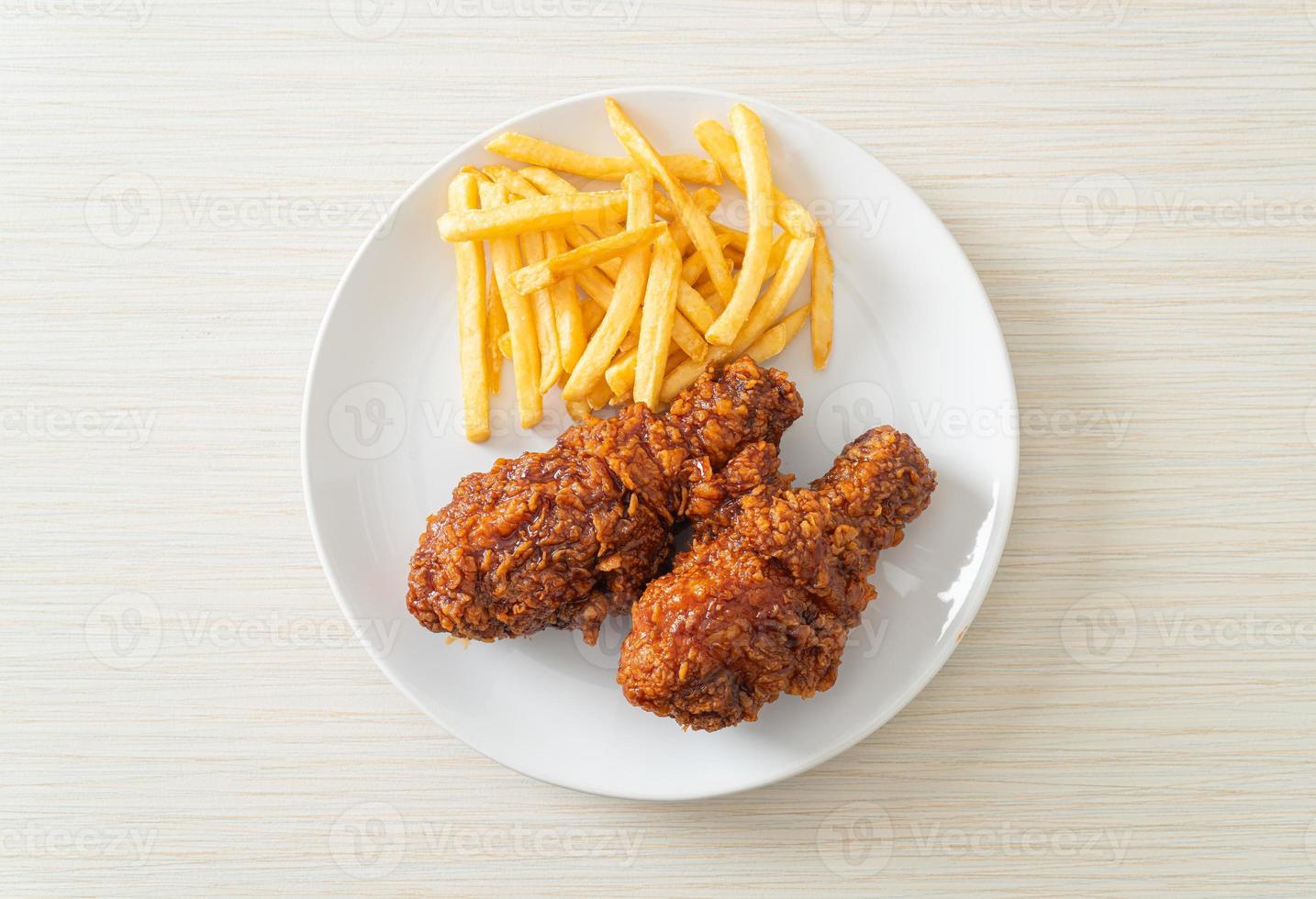 spicy Korean fried chicken with fries photo