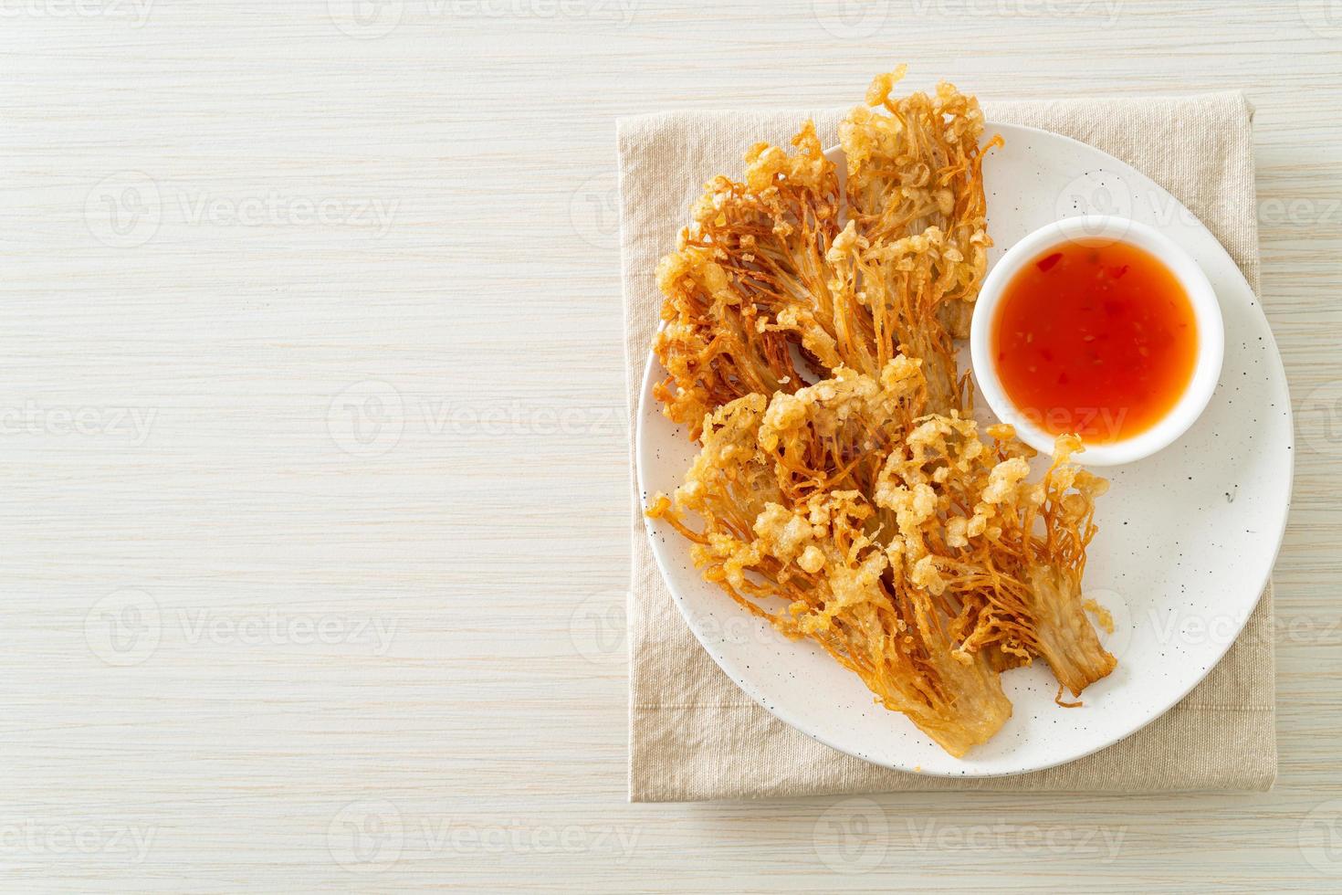 deep fried enoki mushroom or golden needle mushroom with spicy dipping sauce photo