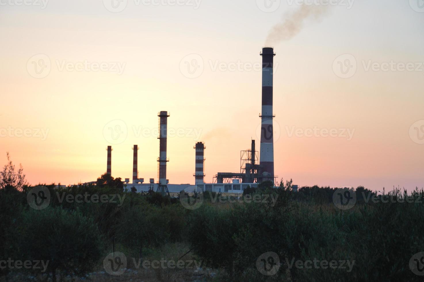 Panorama of a smoking chimney of a factory photo