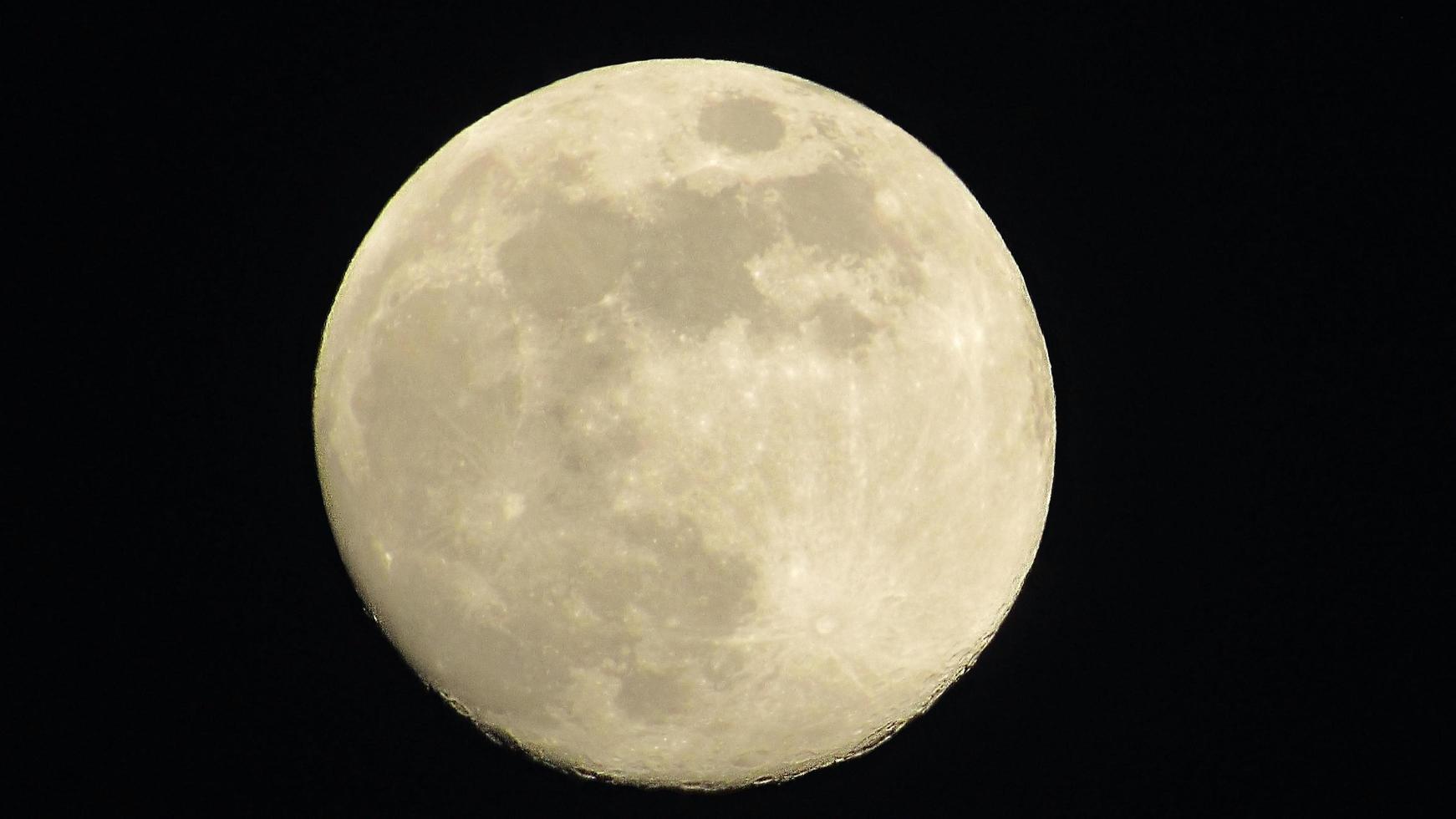 Full moon in the night sky. Moon on the black background photo
