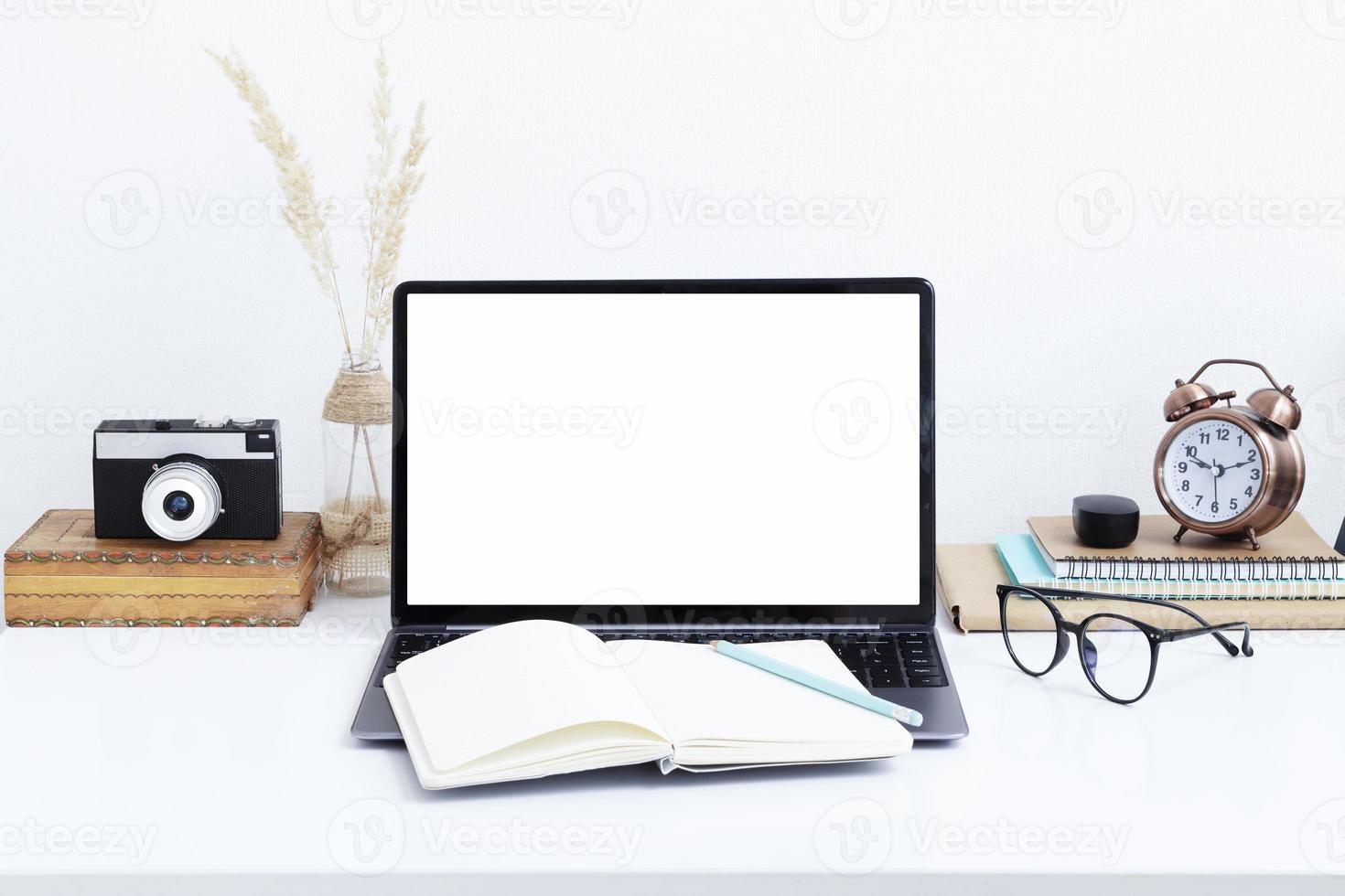 Blank laptop screen mockup, vintage camera and glasses. Work online, quarantine study, freelancer concept photo