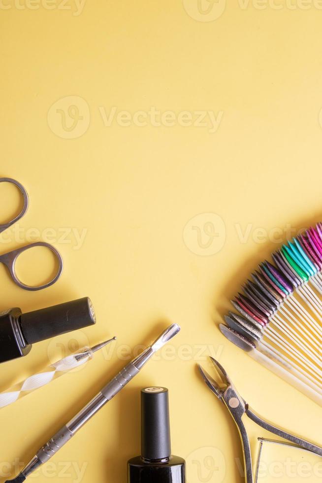 Flat lay manicure tools on a colored background with copy space photo
