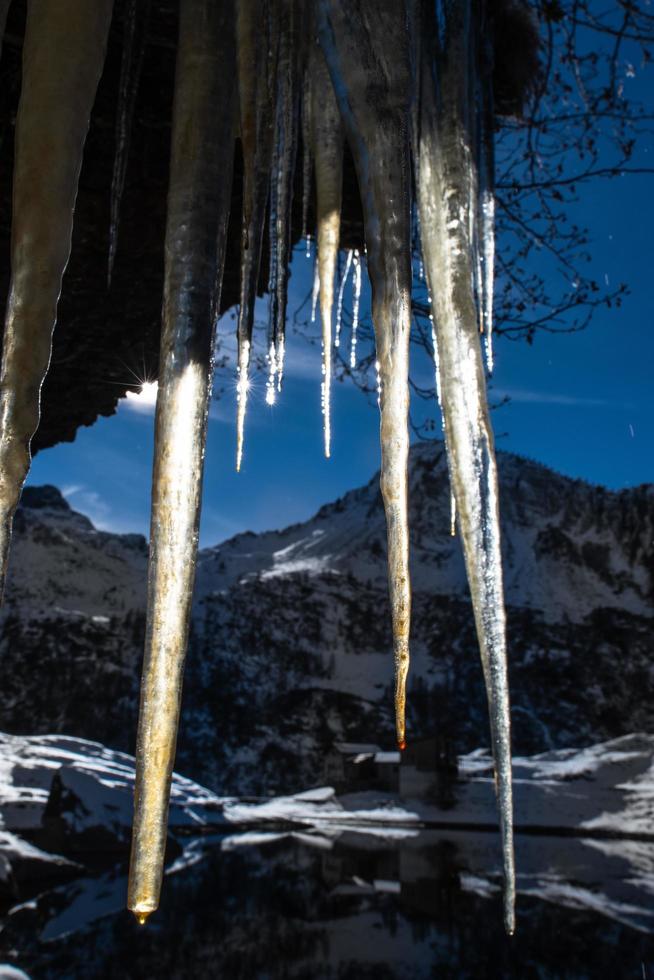 Stalactites ice in the mountains lluminated by the sun photo