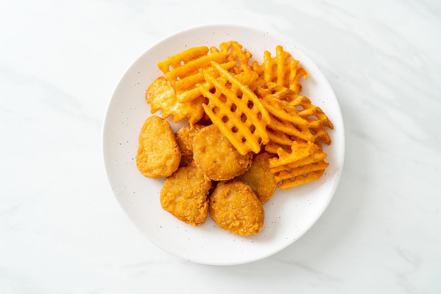 fried chicken nuggets with fried potatoes photo