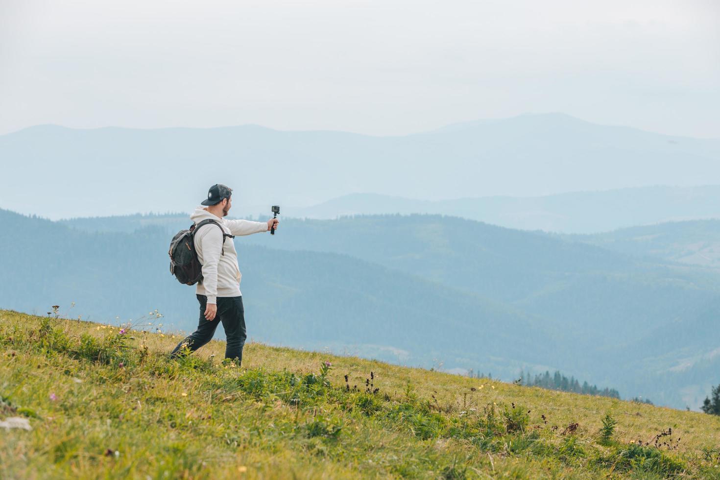 Man with backpack hiking in mountains photo