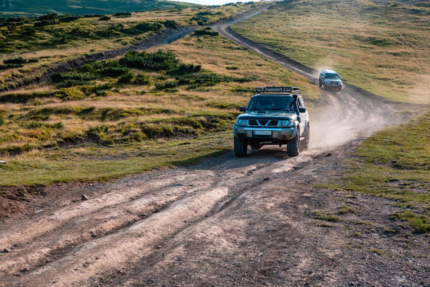 SUV car on the top of ukraine carpathian mountain range photo