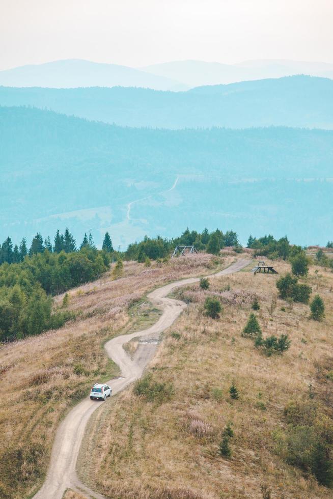 Off road car travel by mountains peak autumn season photo