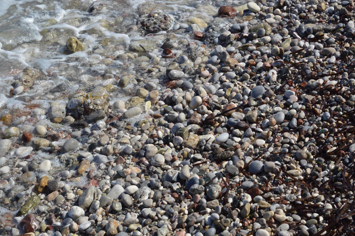 Pebble texture on the Aegean coast in Greece photo