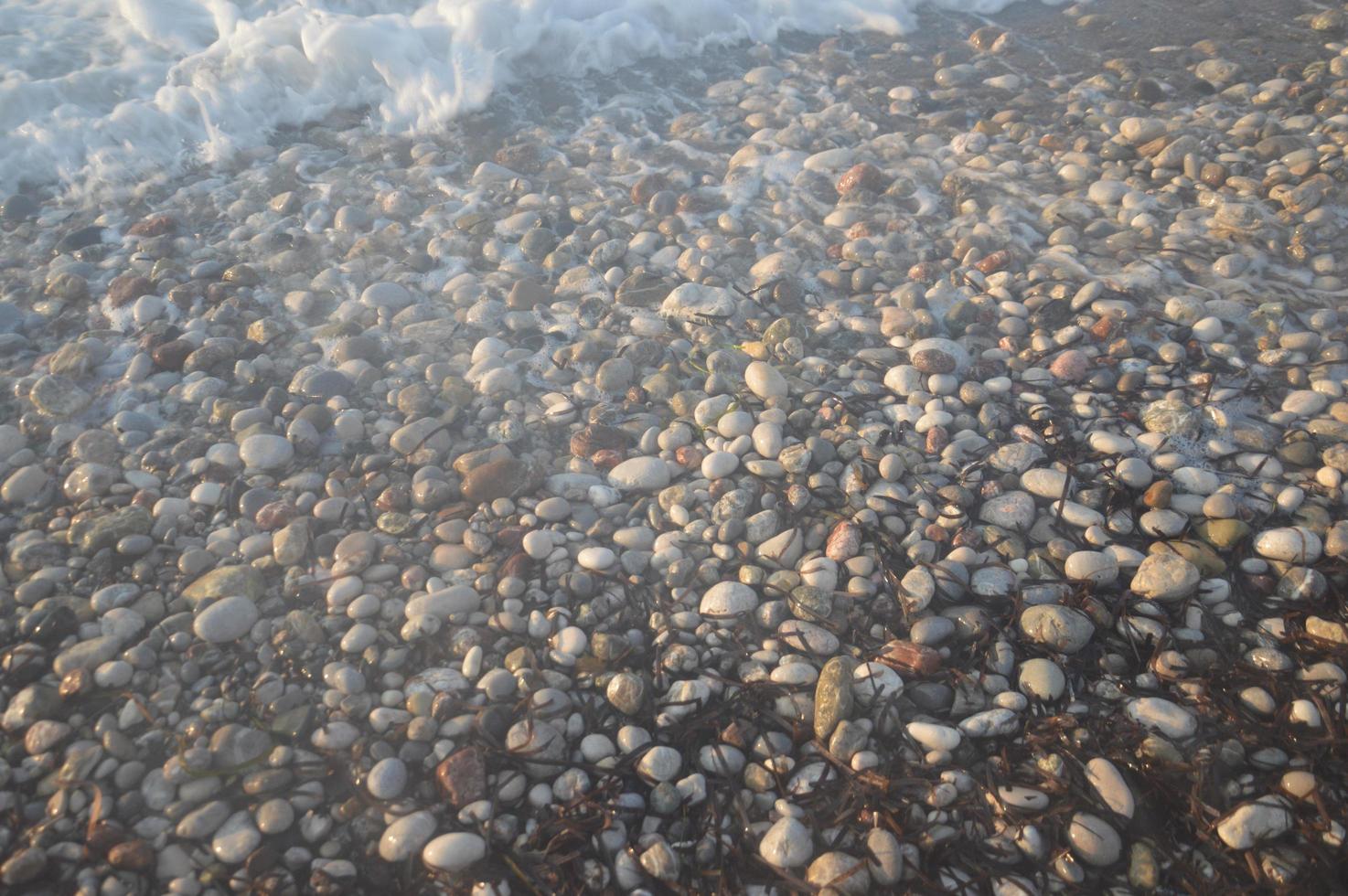 Pebble texture on the Aegean coast in Greece photo