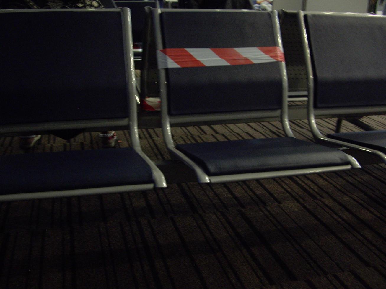 Seats at the international airport indicating the distance between passengers photo