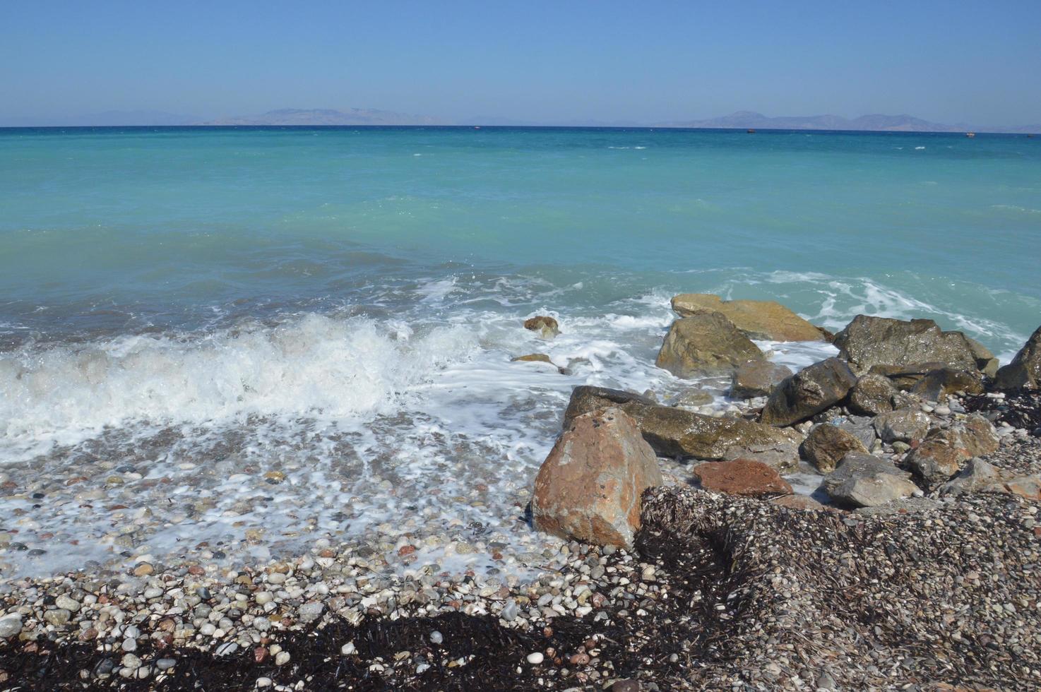 Stones on the background of the Aegean storm on the island of Rhodes in Greece photo