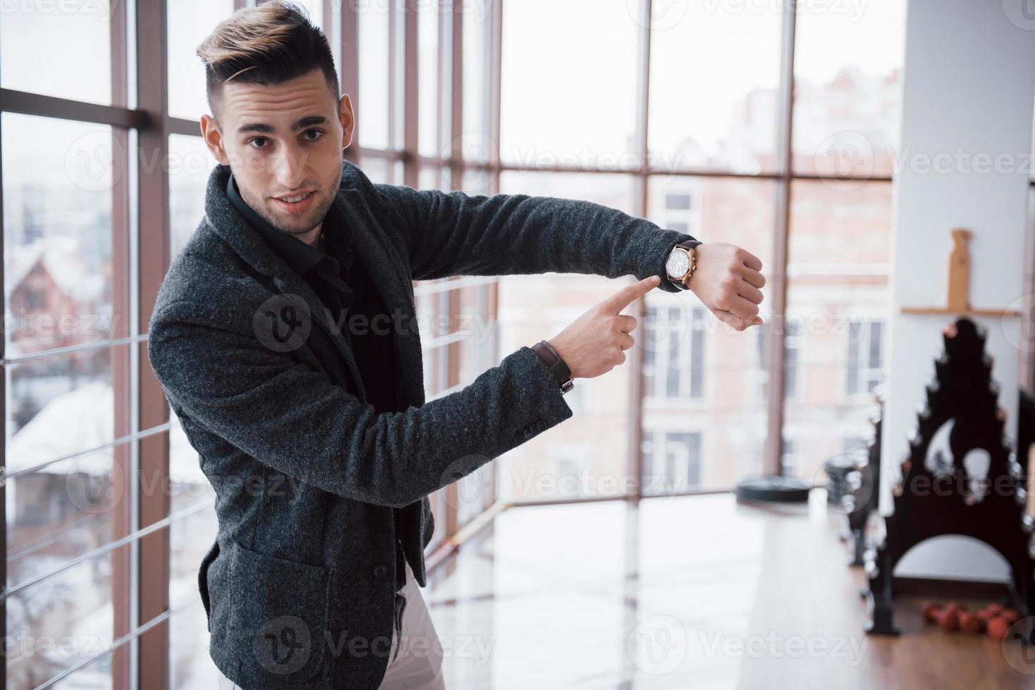 designer watch on businessman hand, he looks on the time and hurrying. photo