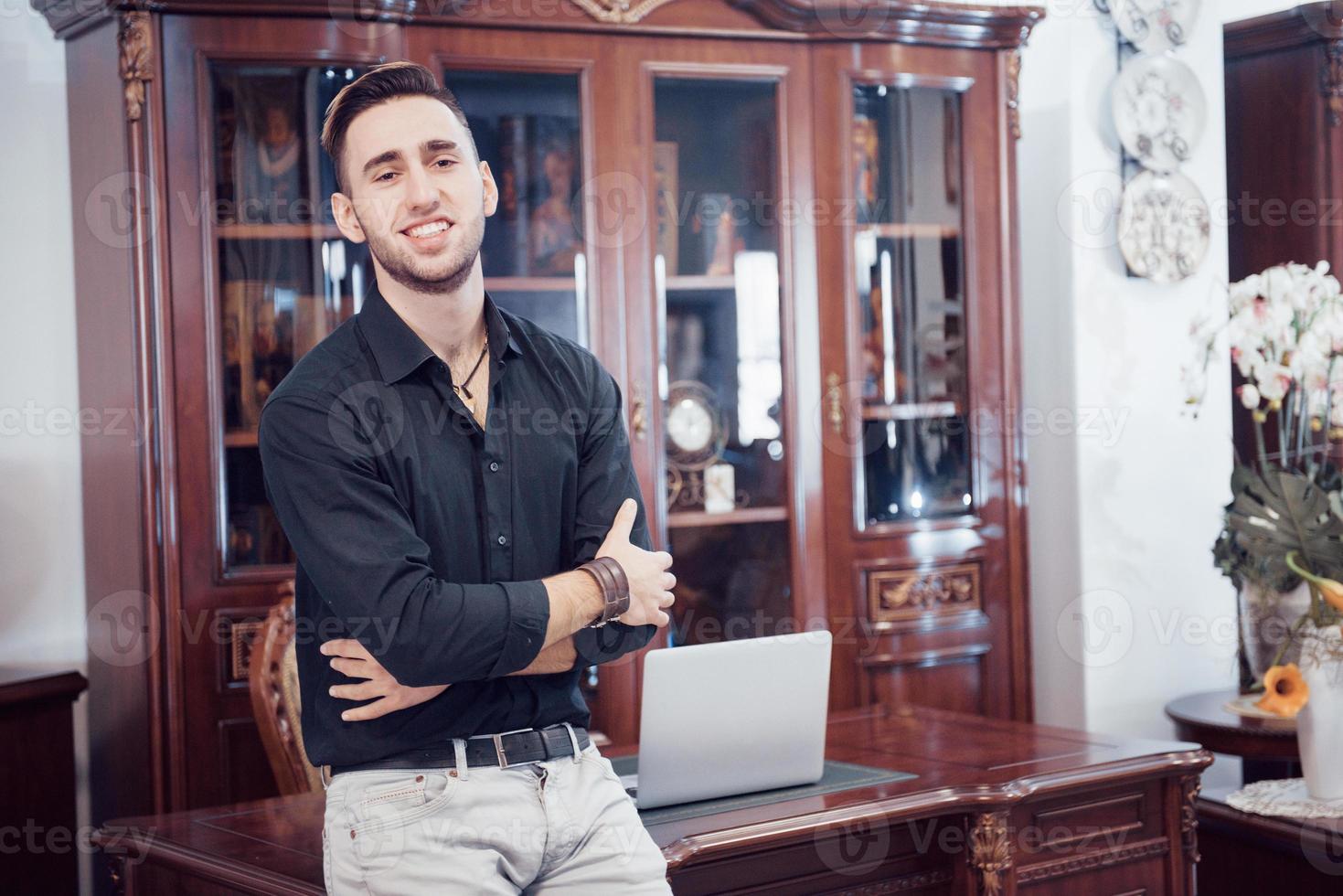 Confident handsome businessman sitting in luxury interior photo