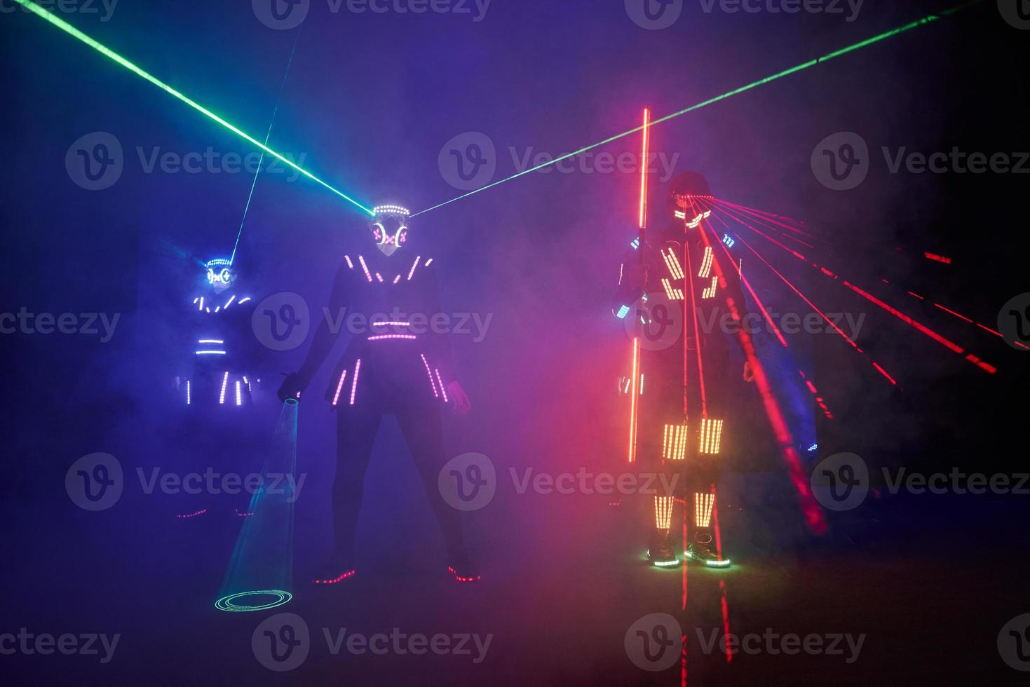 Laser show performance, dancers in led suits with LED lamp, very beautiful night club performance, party photo