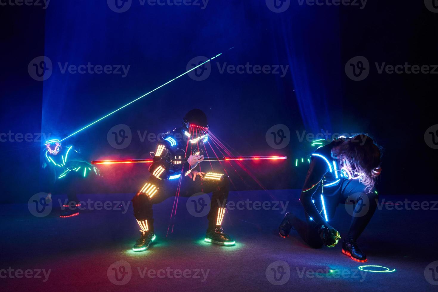 Laser show performance, dancers in led suits with LED lamp, very beautiful night club performance, party photo